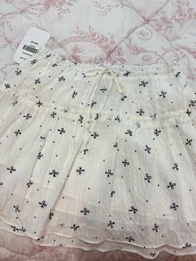 Tiered Cream Mini Skirt with Black Bow Print